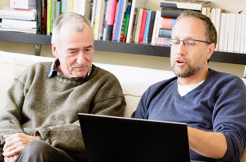 people looking at laptop