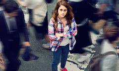 Woman who is around lots of people looking lonely