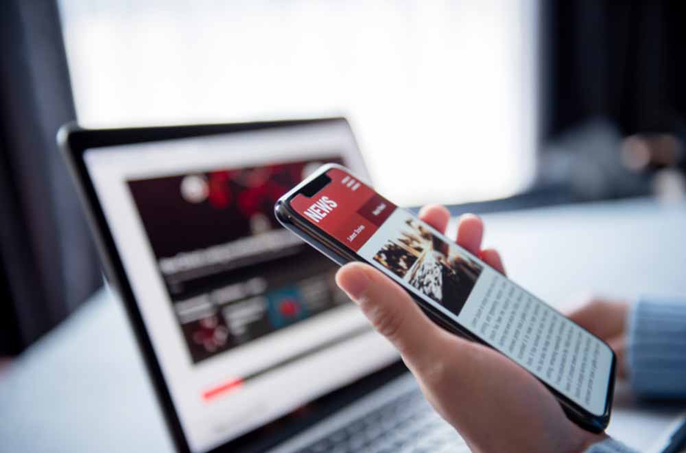 news on a smartphone and desktop computer