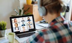 woman wearing headphones looking at screen