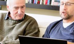 Father and son looking at computer screen